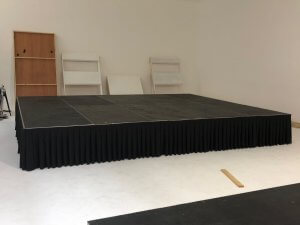 small 5 by 4 meter stage set up in a white room.