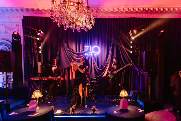 Jazz band performing on custom stage in front of navy drape